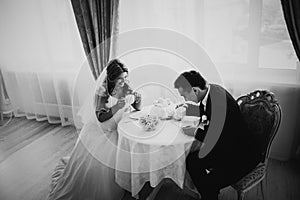 Black white photography bride and groom posing in a hotel room