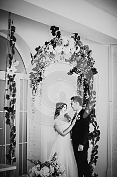 Black white photography bride and groom posing in a hotel room