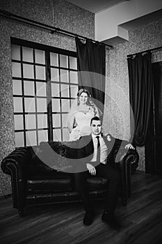 Black white photography bride and groom posing in a hotel room