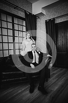 Black white photography bride and groom posing in a hotel room