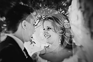 Black white photography happy couple bride and groom embracing they stand on background