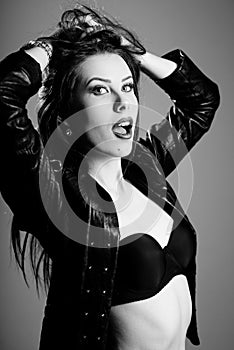 Black and white photography of hot pretty young lady wearing leather jacket sensually looking