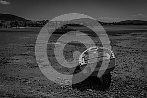 Black & White Photography of a Mediterranean Fishing Boat on the Beach caused by the Low Tide in Euboea - Nea Artaki, Greece