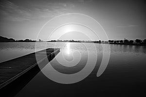 Black and white photography, pier at sunrise in a park of Manresa photo