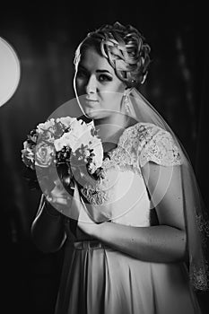 Black white photography portrait of bride on the classic dark background