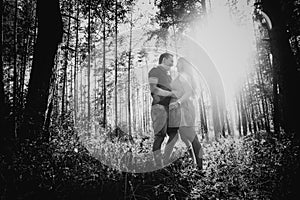 Black white photography romantic young couple kissing on background summer forest