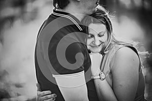 Black white photography romantic young couple kissing on background summer forest