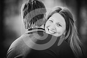 Black white photography romantic young couple kissing on background summer forest