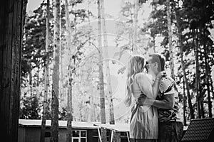 Black white photography romantic young couple kissing on background summer forest