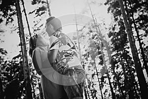 Black white photography romantic young couple kissing on background summer forest