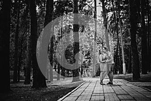 Black white photography romantic young couple kissing on background summer forest