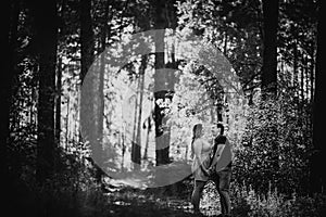 Black white photography romantic young couple kissing on background summer forest