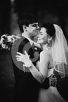 Black white photography wedding beautiful young couple stand on background forest