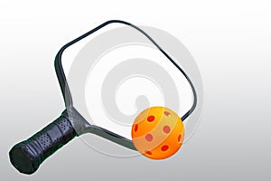 Black and White Pickleball Paddle with Orange ball. photo