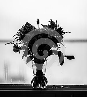 Black and white picture of an autumn flower bouquet in a vase..