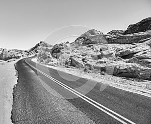 Black and white picture of a deserted road.