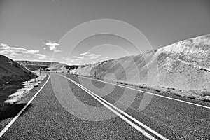 Black and white picture of an empty road.