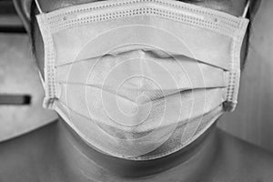 Black and white picture,half-face man wearing black medical mask, Close- up of a man with a surgical mask on his face, Prevent ger