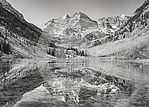 Black and white picture of Maroon Bells reflected in lake.