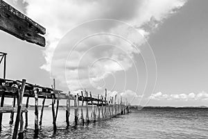 Black and white picture of old bridge to the sea