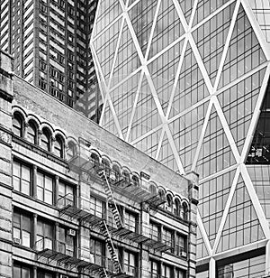 Black and white picture of old building with fire escapes.