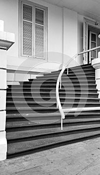 A black and white picture of stone stairs on an old building