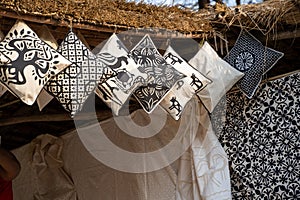 Black and white pillows for sale, hanging from a hut in Faridabad India, at the Surajkund Crafts Mela 2020