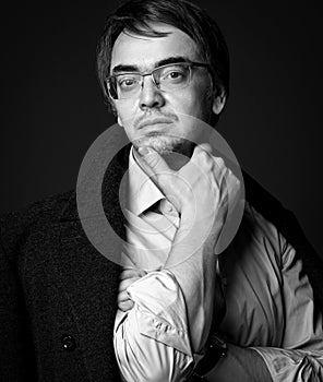 Black and white portrait of adult man literary critic, poet, writer in white shirt and teed jacket on shoulders