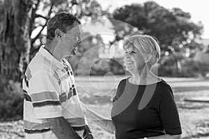 Black and white portrait of American senior beautiful and happy mature couple around 70 years old showing love and affection smili