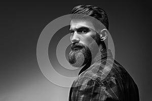 Black and white portrait of bearded handsome man in a pensive mood