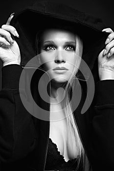 Black and white portrait of beautiful blond woman in hood