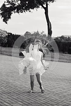 Black and white portrait of Beautiful little girl  Is dancing outside at  summer sunset