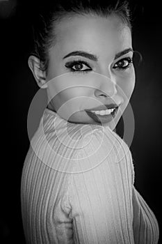 Black and white portrait of a beautiful young woman with curly black hair and red lipstick