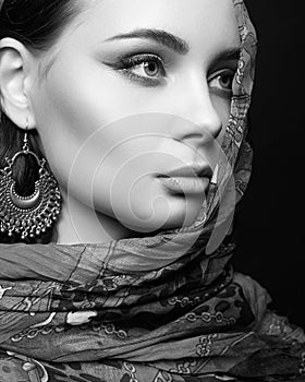 Black and white portrait of beautiful young woman in veil and jewelry. beauty girl in hijab