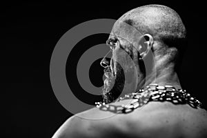 Black and white portrait of a brutal man tearing the chain