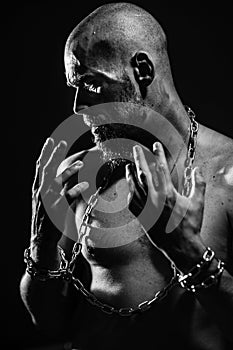 Black and white portrait of a brutal man tearing the chain