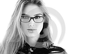 Black and white portrait closeup. Stylish young woman in glasses with a sensual look