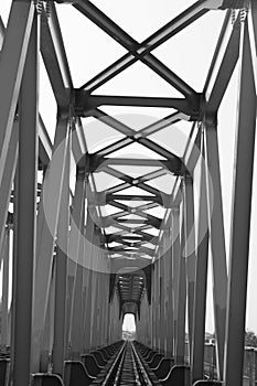 black and white portrait of the construction of a long railway bridge,