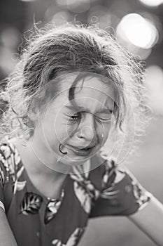 Black and white Portrait of crying sad little girl