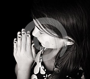 Black and white portrait of a cute girl praying