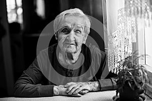 Black and white portrait of an elderly happy woman of 85 years.