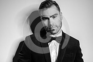 Black and white portrait of elegant fashion model in tuxedo