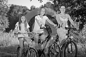 Black and white portrait of family cycling at meadow