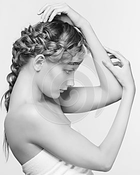 Black and white portrait in high key tone female with creative hairdo braids