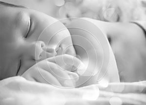 A black and white portrait, macro shot. Mom and her baby. The concept of a happy family. Beautiful conceptual image of motherhood