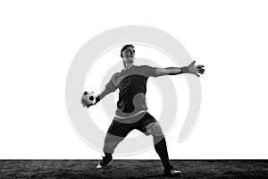 Black and white portrait of male soccer football goalkeeper psoing isolated over white background. Monochrome. Concept