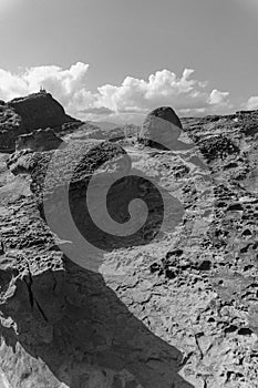 Black and White Portrait of Potholes and Melted Rock Formations With Clear Blue Sky Background in Yehliu Geopark, Taiwan