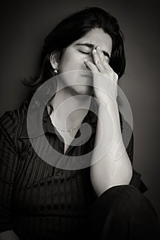 Black and white portrait of a sad hispanic woman