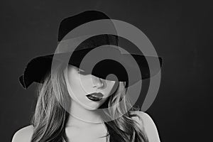 Black and white portrait of sensual woman model in classic hat