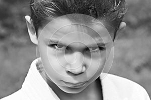 Black and white portrait of a serious boy in a kimono